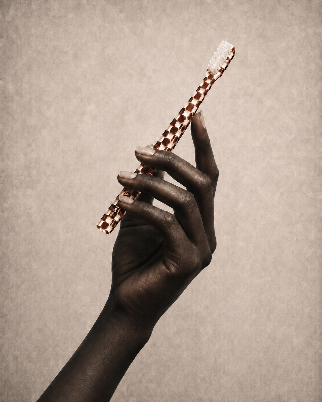 A hand holding the Anouk Damier toothbrush